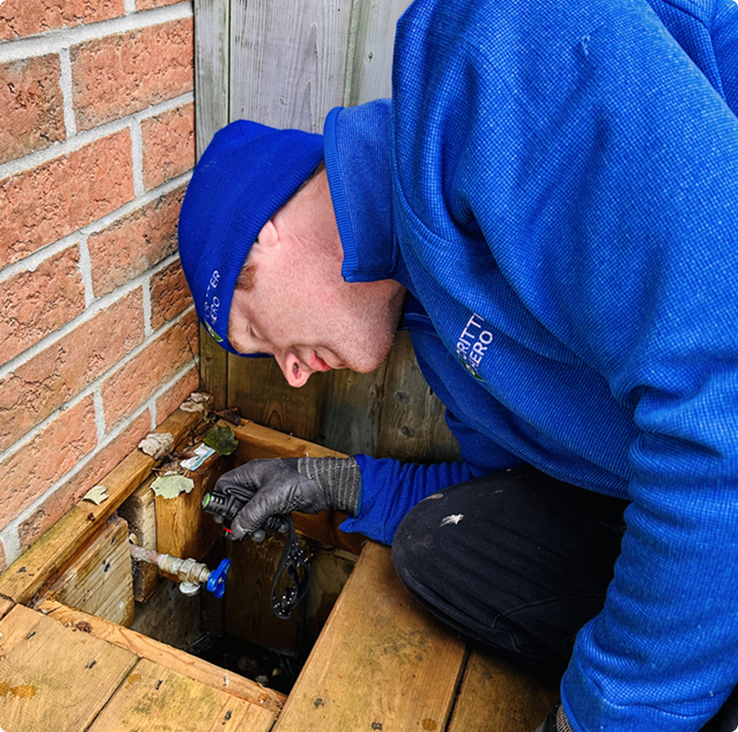 Technician inspecting a foundation-level wildlife entry point